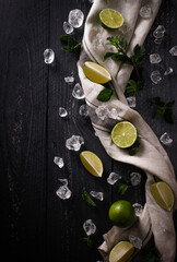 Mojito ingredients, lemon, mint on dark background