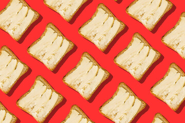 Butter and bread on a red background. Creative minimal style.