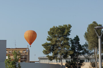 Hot air balloon festival in summer, balloonists in the blue clear sky over the city
