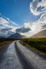 a lonely road heading towards the valley of glencoe in the argyll region of the highlands of scotland in summer