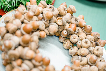 Florist at work: woman making rose hip and hawthorn wreath