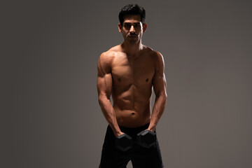 Fototapeta premium Confident Hispanic Man Exercising At Studio