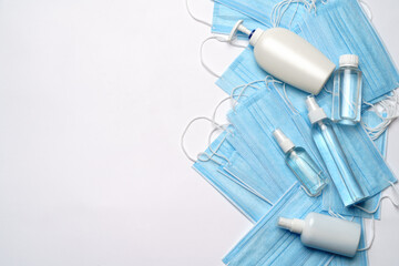 Fototapeta premium bottle of lotion, sanitizer or liquid soap and protective mask over light grey background