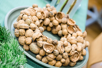 Florist at work: woman making rose hip and hawthorn wreath