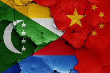 flags of Comoros and China painted on cracked wall