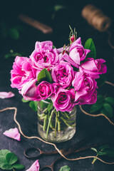 Bouquet of small garden roses in jar with water