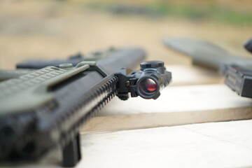 Hunting rifle with collimator sight, close-up.