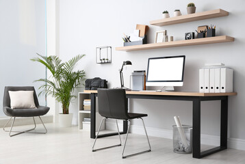 Modern computer on table in office interior. Stylish workplace