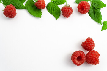 Ripe raspberries isolated on white background close-up. Beautiful red fresh raspberries with leaves along the contour on the table. Top view. Banner for the site. Free space for text