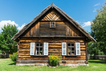 Fototapeta na wymiar Wooden cottage house countryside landscape. Summer away from the city cozy cabin in forest. Vintage rustic architecture. Village sunny day.