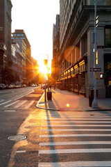 Sunset light shines on an empty crosswalk at the intersection of 23rd Street and 5th Avenue in Manhattan, New York City