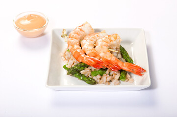 prawns skewer on a white background with asparagus and spelled, dietetic meal