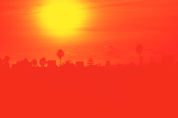 Naklejka na ściany i meble Sunset over Los Angeles skyline with buildings and palm trees in California