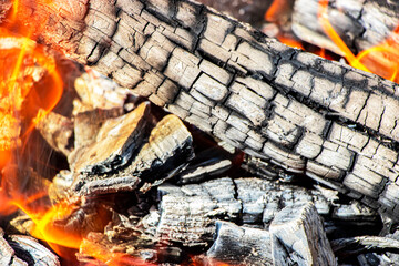 Burning firewood and coals in the grill. Close-up. Macro shooting. Burning fire. Grilling meat. Coals for frying