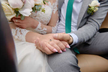 Newlywed hands with wedding rings, copy space. Wedding couple, bride and groom, hands with rings, closeup