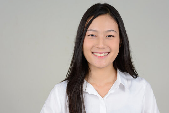 Portrait Of Young Beautiful Asian Businesswoman Against White Background