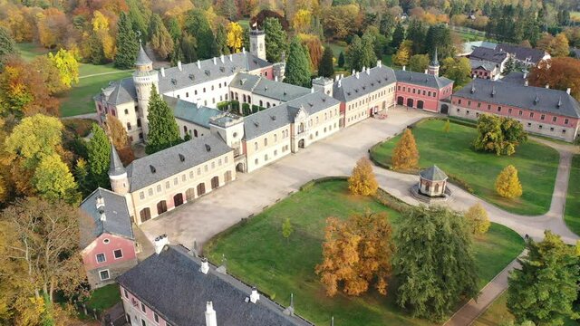 View from drone of impressive medieval Sychrov Castle with large park on sunny autumn day, Liberec Region, Czech Republic