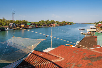 Bojana river delta and Ada Island in Ulcinj, Montenegro. - It is a popular tourist destination with long sandy beach and traditional seafood restaurants. People and signs unrecognizable.