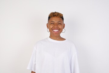 Cute young blonde female blinking her eyes with pleasure having happy expression. Facial expressions and people emotions concept.