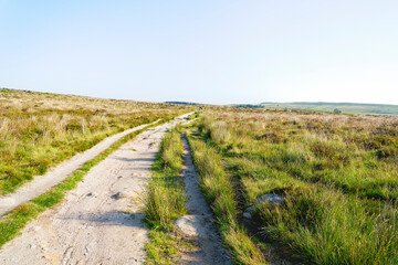 Fototapeta na wymiar Wide dirt road going across Derbyshire moorland