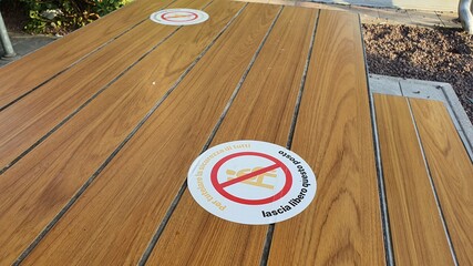 social distancing sign on the tables of a fast food. keep a social distance concept CORONAVIRUS...
