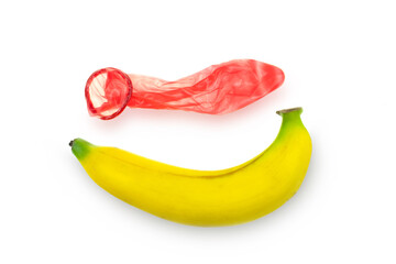 Red condom wear a banana on a white background concept safe sex prevention of sexually transmitted diseases and contraceptive
