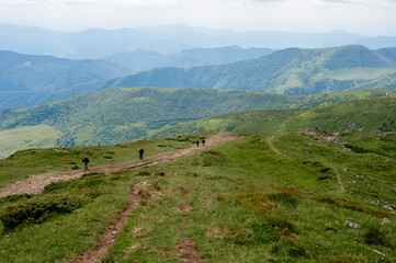 Fototapeta na wymiar a group of tourists who climb up the mountain range