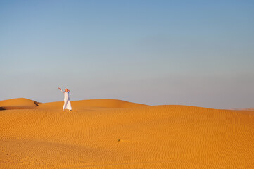 Fototapeta na wymiar Portrait of thirsty Arabic man on a middle of yellow desert.
