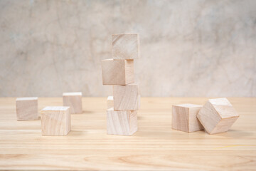 Wooden toy cubes on wooden table ang grey background