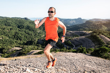 Athletic young man running in the nature. Healthy lifestyle