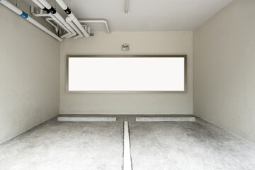Empty car parking on ground floor with blank advertising billboard