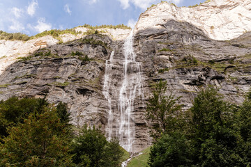 Fototapeta na wymiar Scenic view on green mountings and sky in Lauterbrunnen Valley, Switzerland