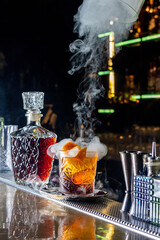 Bartender prepair cocktail in american bar. Classic smoked negroni cocktail