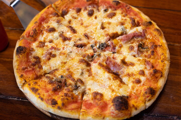 Close up pizza on woodden plate.