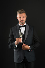 Handsome man tuxedo suit drink champagne black background, celebrate anniversary concept