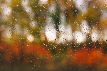rain drops on the window, golden in the fall. rainy season. storm, hurricane, downpour.