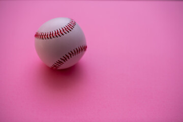 Baseball isolated against pink background with copy space
