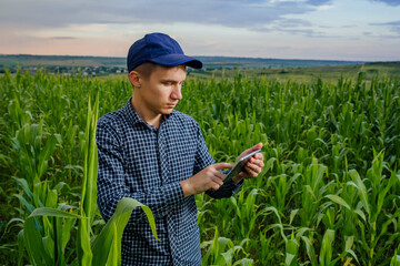 young farmer using a tablet PC, front view on modern farmer with digital tablet, Farmers and...