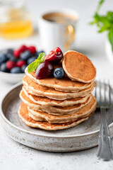 Vegan oat pancakes with berries on plate. Gluten free pancakes stack