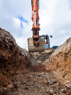 Hydraulic Excavator digging a trench for building foundations