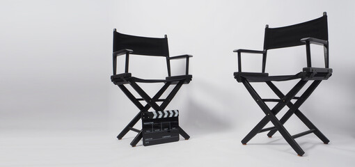 Two black director chair and clapper board use in video production or movie and cinema industry on white background.