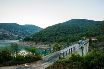 Fototapeta na wymiar 4x4 car crossing dangerous bridge in Aragon, Pyrenees, Spain