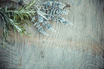 Beautiful Greek wild lavender and rosemary on natural wooden background. Copy space for text. Aromatherapy and essential oil concept. Space for you product.