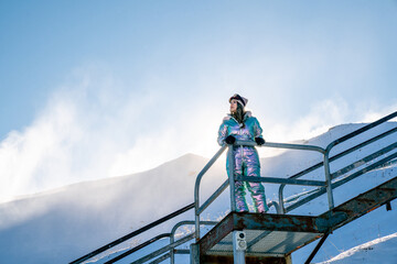 Beautiful asian woman enjoying and relaxing view with snow flake on snow mountain during winter in New Zealand.