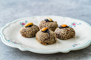 Traditional Turkish Dessert Balbadem / Bal Badem also Called Chocolate Sekerpare with White Poppy Seeds, Sherbet and Peanut.