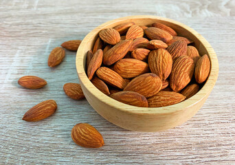 almond on wooden table with spoon, Almond in wooden bowl.