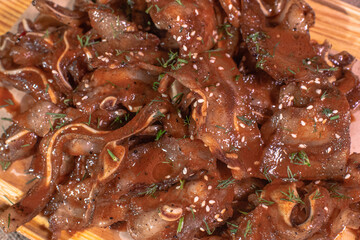 Freshly cooked pork ears in Tabasco sauce
