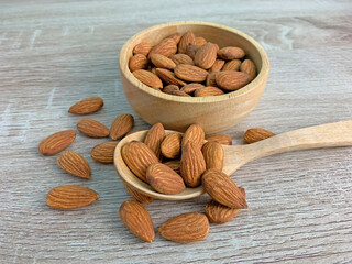 almond on wooden table with spoon, Almond in wooden bowl.