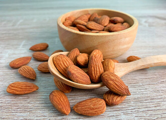 almond on wooden table with spoon, Almond in wooden bowl.