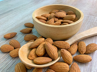 almond on wooden table with spoon, Almond in wooden bowl.
